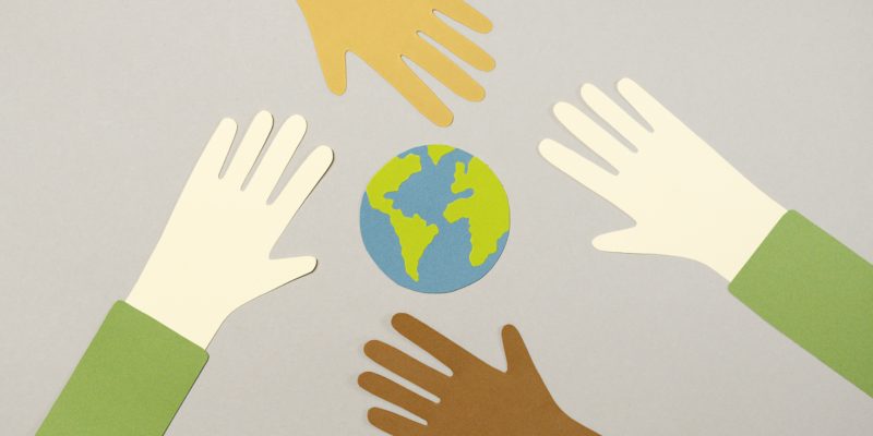 Earth Illustration with diverse hands reaching together