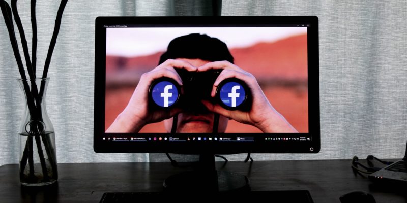 Facebook headline generator-looking at facebook-laptop background