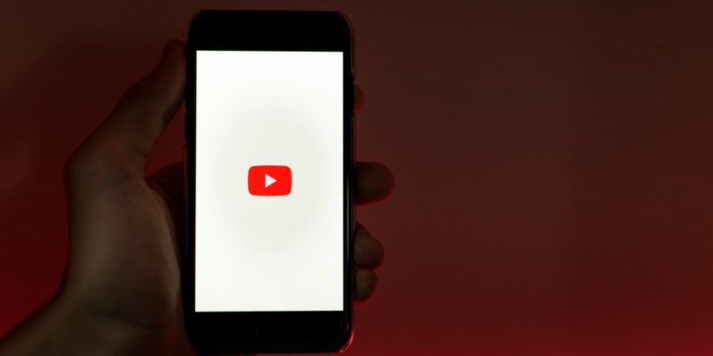 phone in hand-youtube titles-copy ai